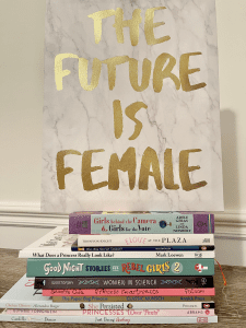 Canvas print with The Future Is Female written in gold letters on top of a stack of women empowering books